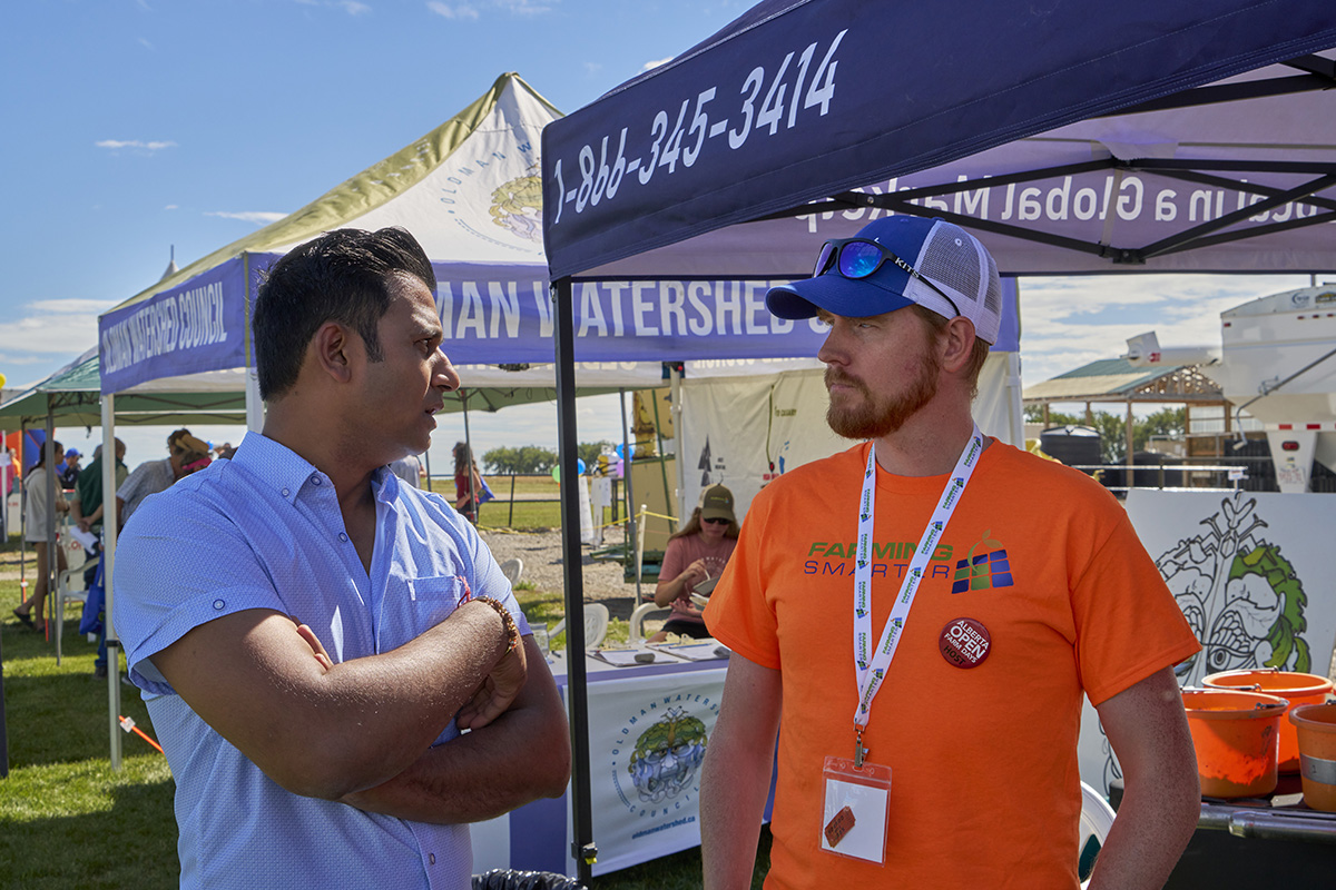 Thierry Fonville talks with a visitor at Farming Smarter's soil health booth during the 2025 Open Farm Days event.